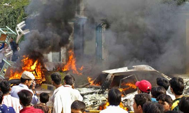 Lahore Police Thwart Mob Attack on Ahmadi Worship Place: A Case of Religious Intolerance and Persecution Mob burning cars in protest
