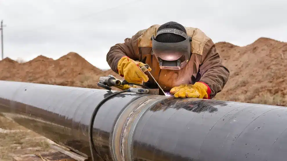 The New Energy Map: How Geopolitics is Redrawing Global Power Labourers Laying Pipeline to Transfer Energy Resources