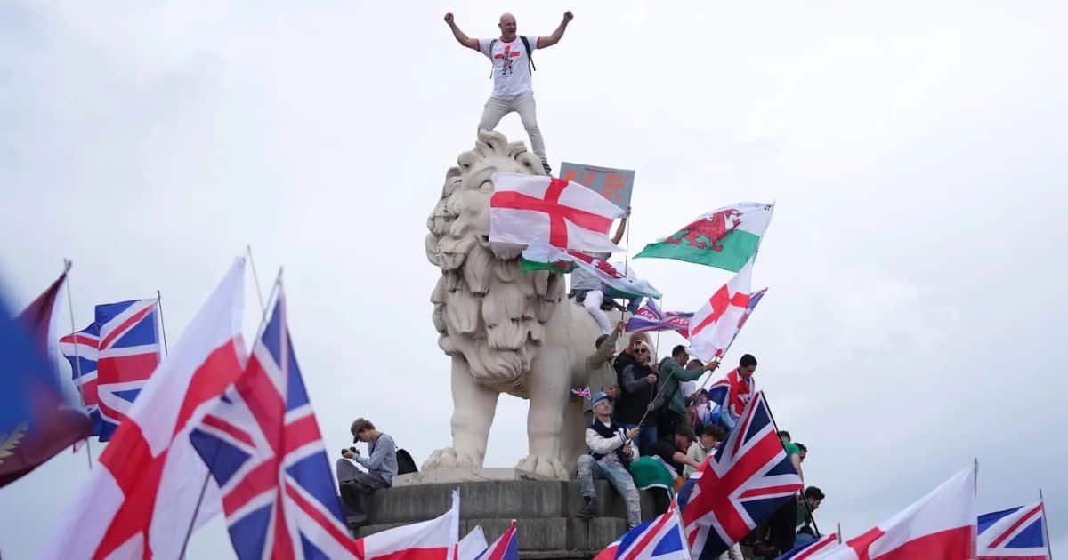 Crowd with UK flags lion statue Crowd with UK flags lion statue