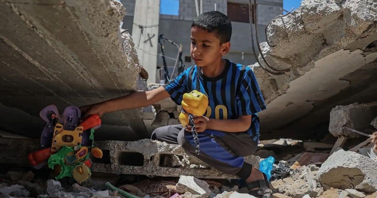 The Weaponization of Human Rights How Global Powers Selectively Invoke International Law Against Adversaries A young boy sits amid rubble and destroyed concrete